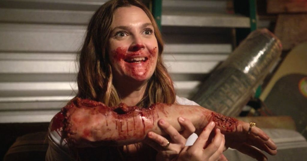 Drew Barrymore as a zombie chowing down on a limb 